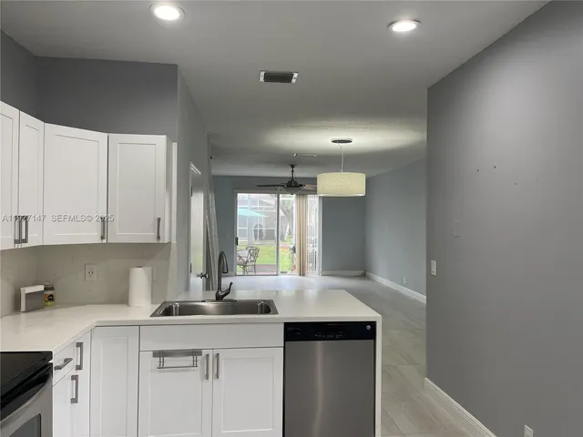 a kitchen with a sink cabinets and window