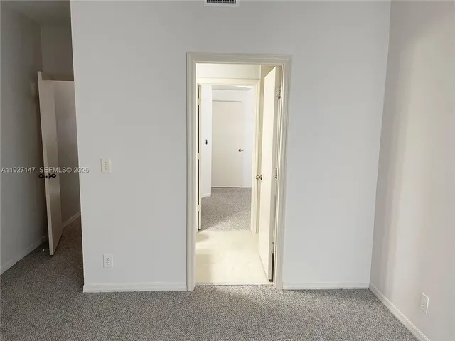 a view of cabinets with refrigerator