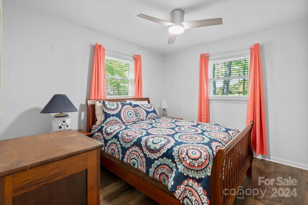1405 Deer Run Road Ridgeway, SC 29130 - Photo 20 of 48 a bedroom with a bed a chandelier and a window