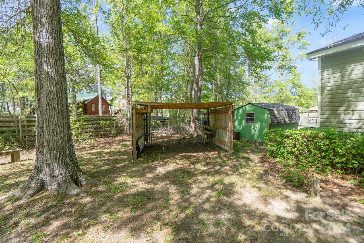 1405 Deer Run Road Ridgeway, SC 29130 - Photo 29 of 48 a view of a yard with plants and large trees