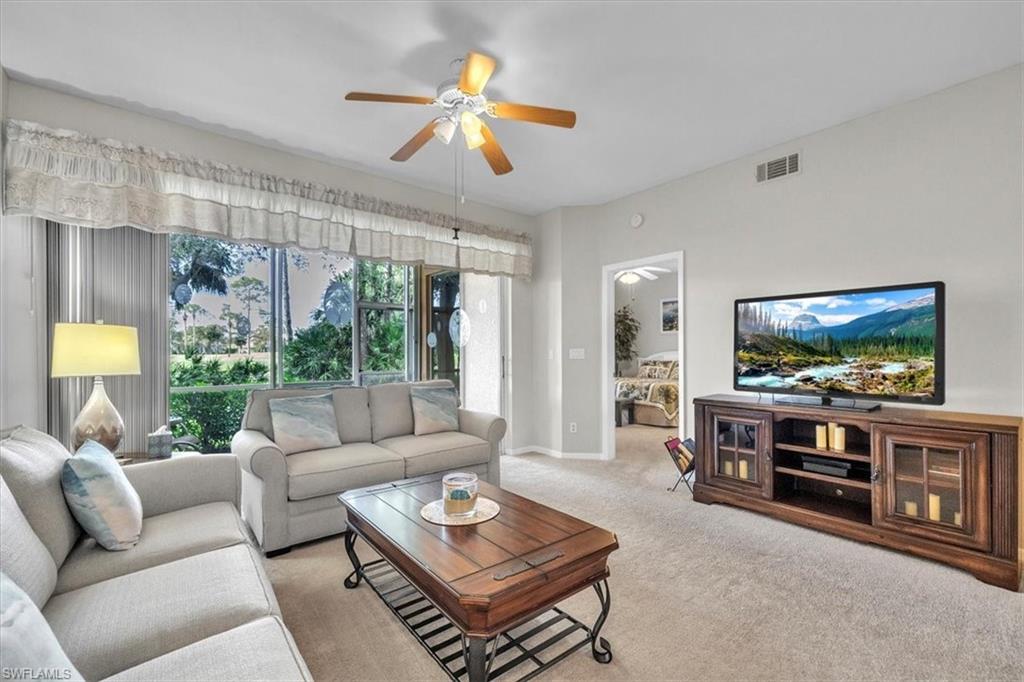 8075 Tiger Cove, Unit 1706 Naples, FL 34113 - Photo 5 of 50 Carpeted living room featuring ceiling fan