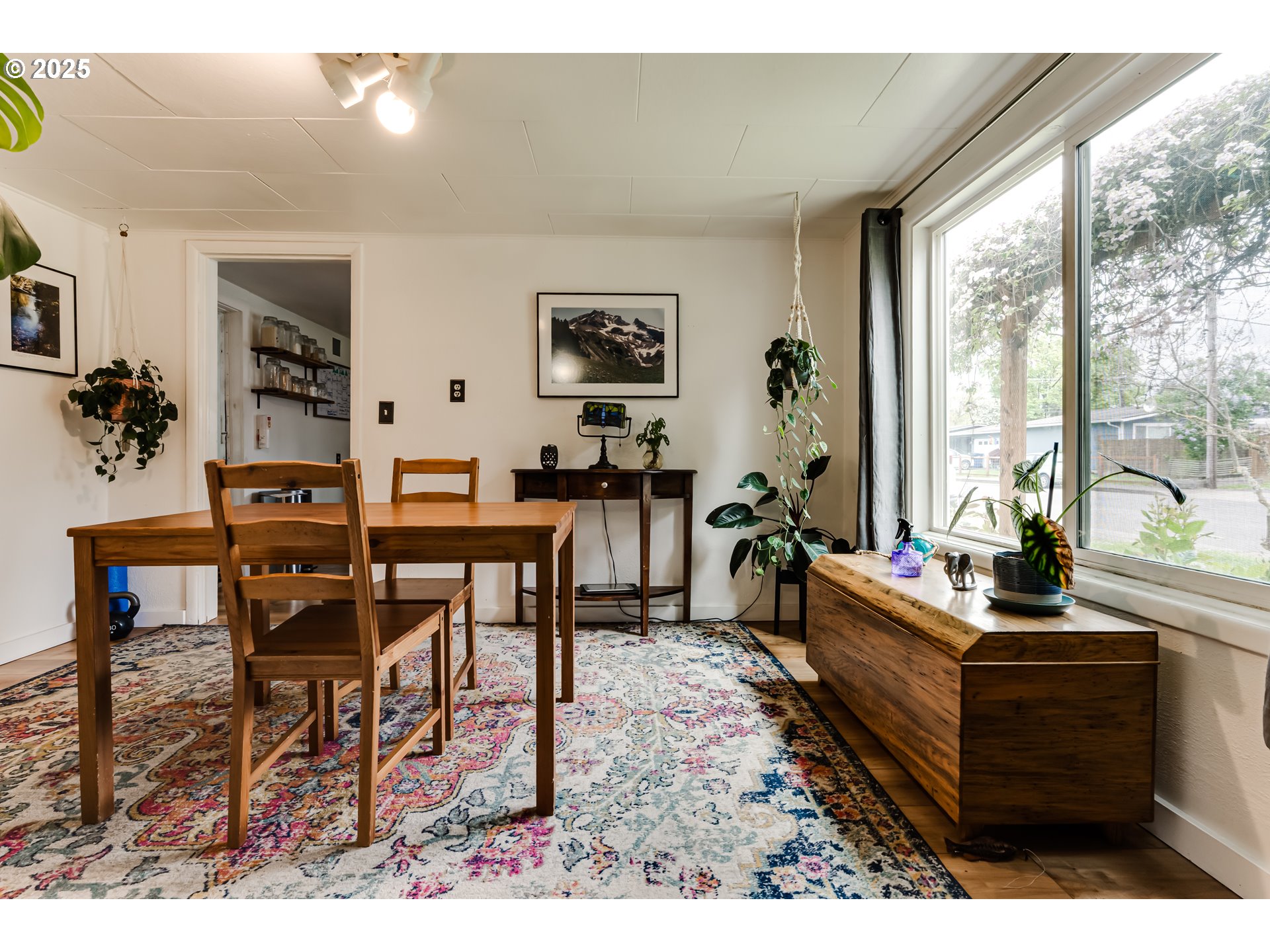 144 West K Street Springfield, OR 97477 - Photo 8 of 33 a living room with furniture a table and large windows
