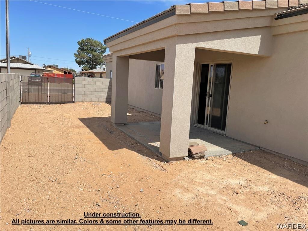 3595 North Verdugo Road Kingman, AZ 86409 - Photo 20 of 21 Rear exterior with a covered patio area and sliding glass door access