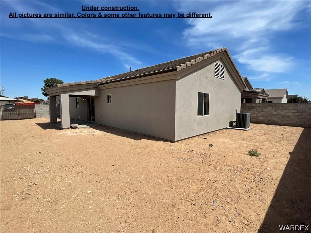 3595 North Verdugo Road Kingman, AZ 86409 - Photo 21 of 21 Spacious backyard with stucco exterior, a covered patio area, and a block wall perimeter
