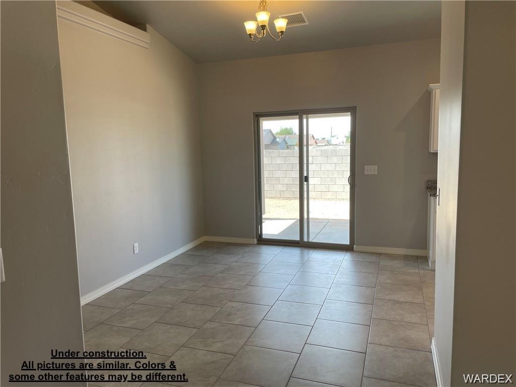 3595 North Verdugo Road Kingman, AZ 86409 - Photo 5 of 21 Sliding glass door opening to a concrete patio and block wall fencing
