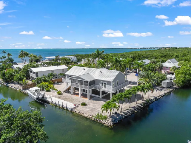 a aerial view of a house with a garden and lake view