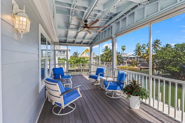 a balcony with furniture and a potted plant