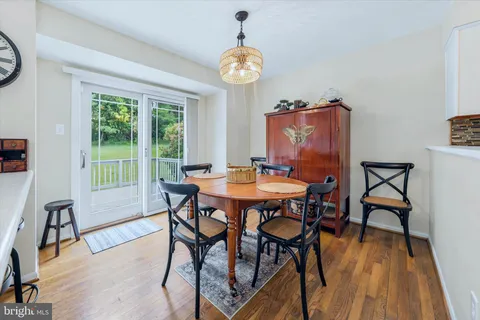 a dining room with furniture a rug and a chandelier