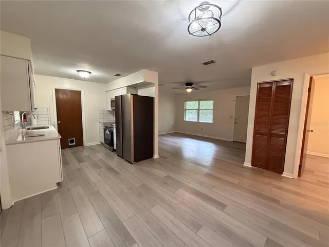 a view of a livingroom with furniture wooden floor and windows