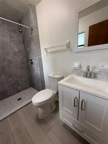 a bathroom with a toilet sink and shower