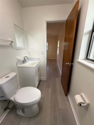 a white toilet sitting next to a bathroom sink