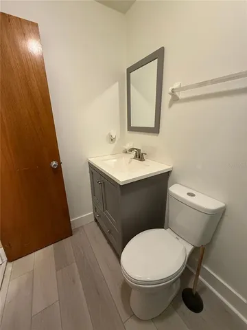 a bathroom with a toilet a sink and mirror