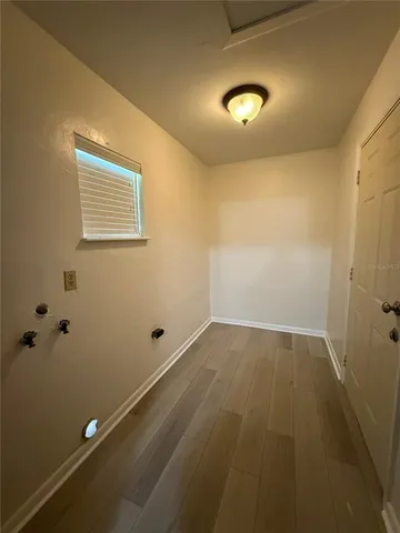 a view of a room with wooden floor