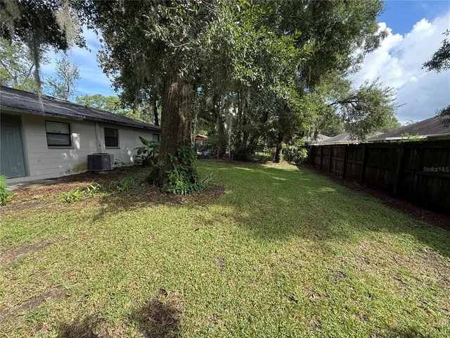 a backyard of a house with lots of green space
