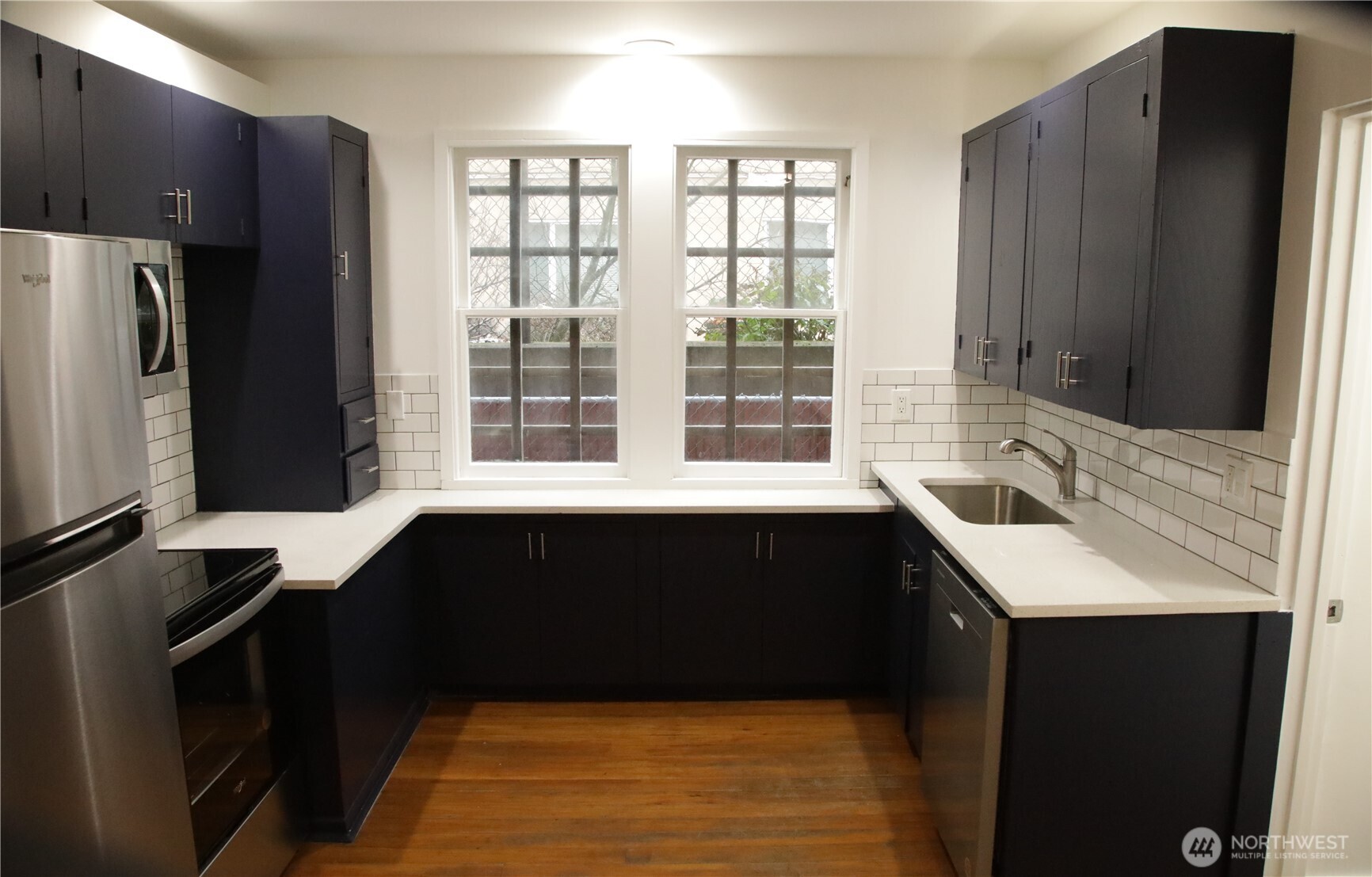 417 Minor Avenue North Seattle, WA 98109 - Photo 23 of 36 a kitchen with a sink a counter top space and stainless steel appliances