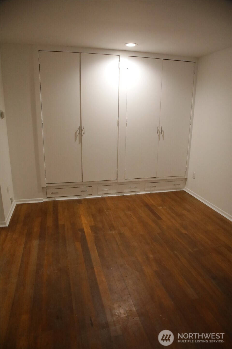 417 Minor Avenue North Seattle, WA 98109 - Photo 25 of 36 an empty room with wooden floor and windows