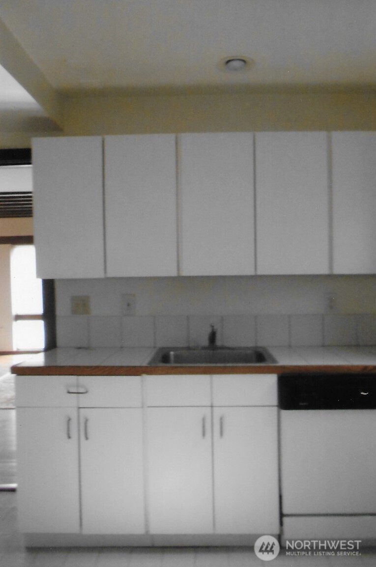 417 Minor Avenue North Seattle, WA 98109 - Photo 27 of 36 a kitchen with a sink and cabinets
