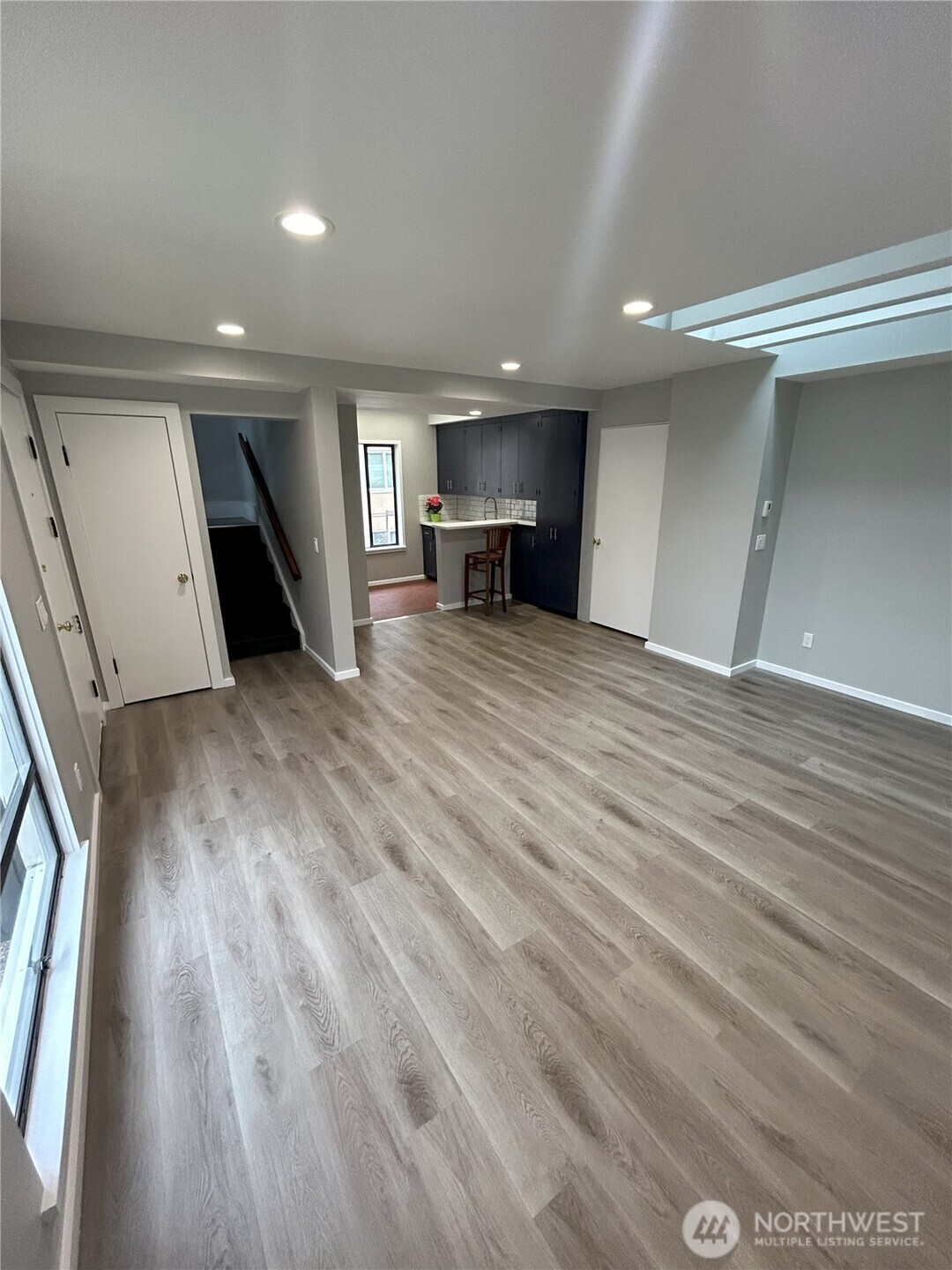 417 Minor Avenue North Seattle, WA 98109 - Photo 34 of 36 an empty room with wooden floor kitchen view and windows