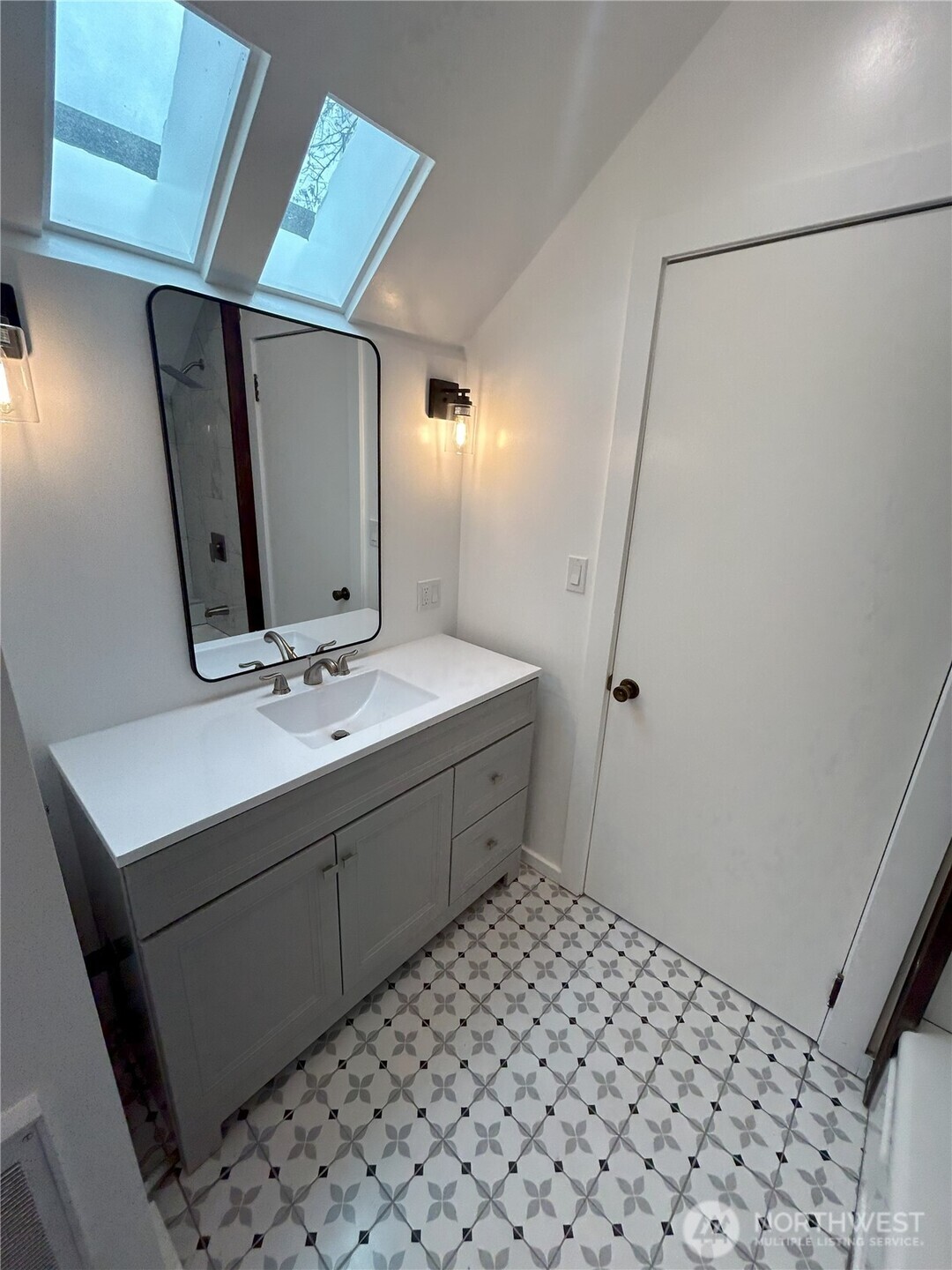 417 Minor Avenue North Seattle, WA 98109 - Photo 35 of 36 a bathroom with a sink and a mirror