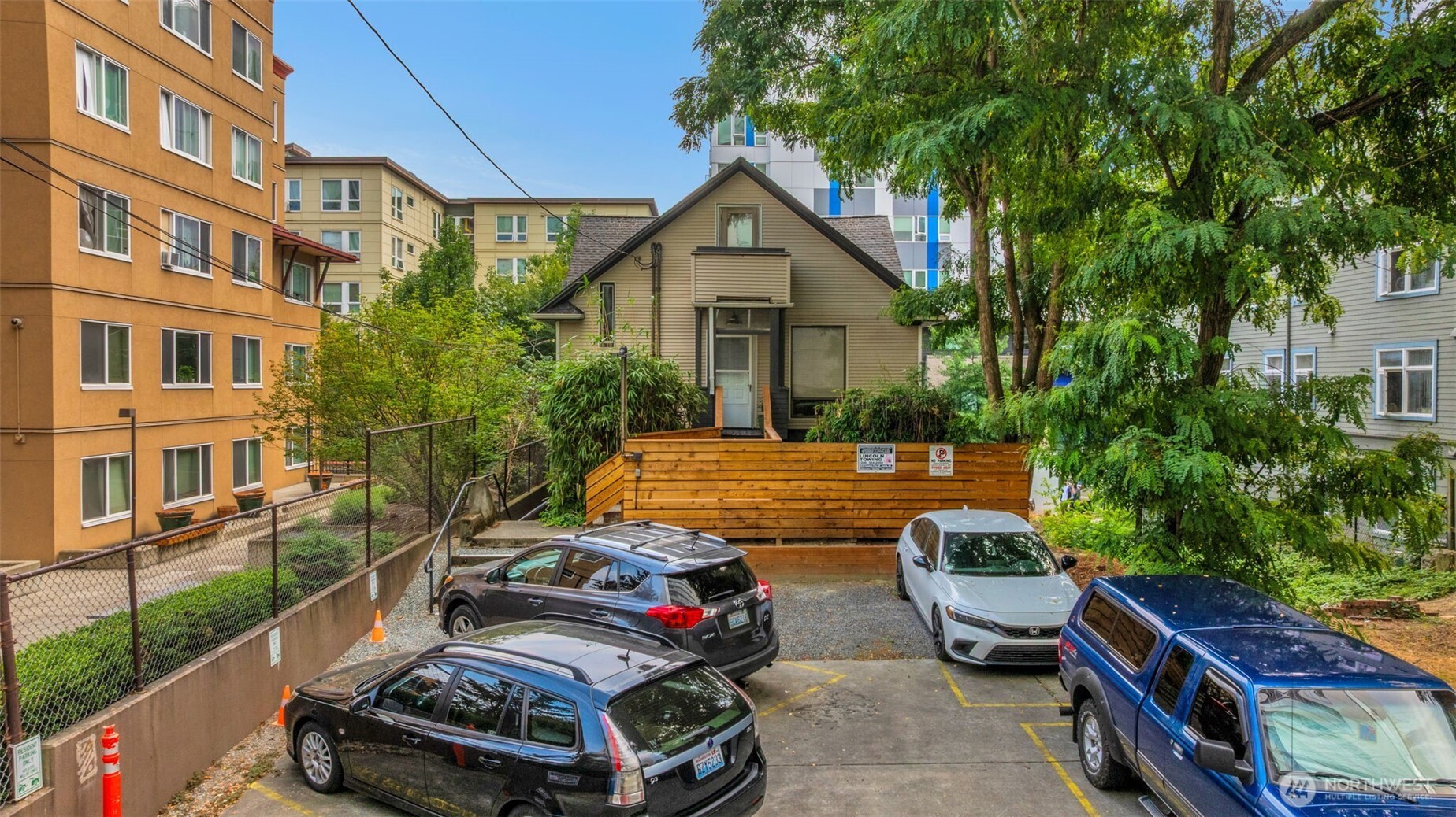 417 Minor Avenue North Seattle, WA 98109 - Photo 5 of 36 a car parked in front of a brick house with a small yard