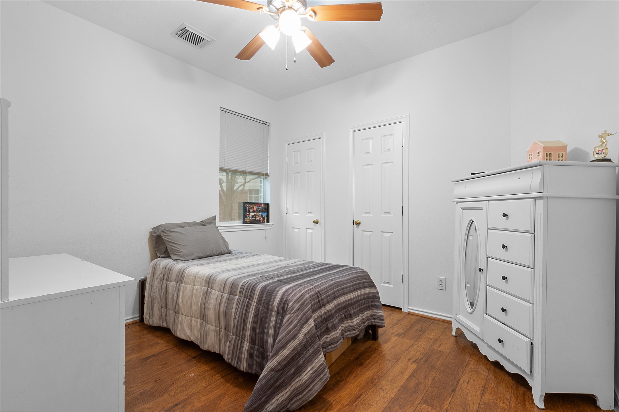 21014 Jessica Rose Lane Spring, TX 77379 - Photo 18 of 30 a bedroom with a bed and a chandelier