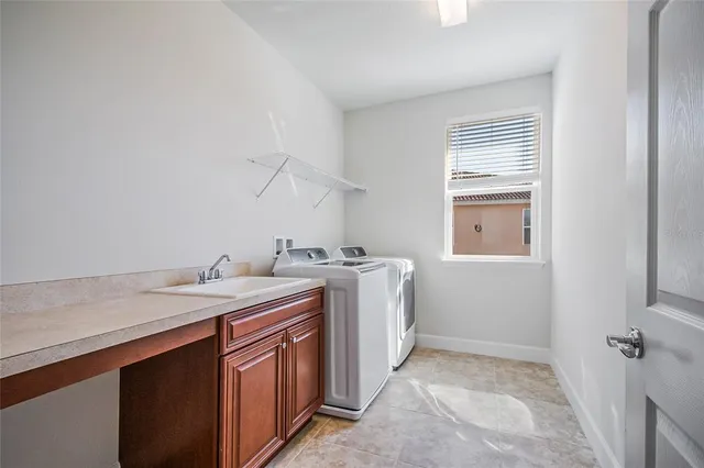 a living room with patio furniture and a chandelier