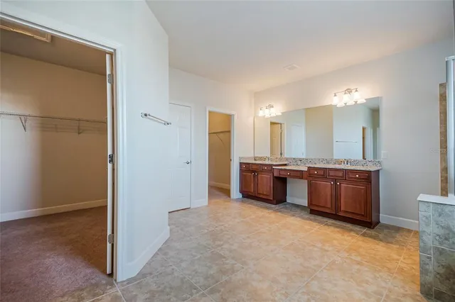 a living room with stainless steel appliances lots of furniture and kitchen view