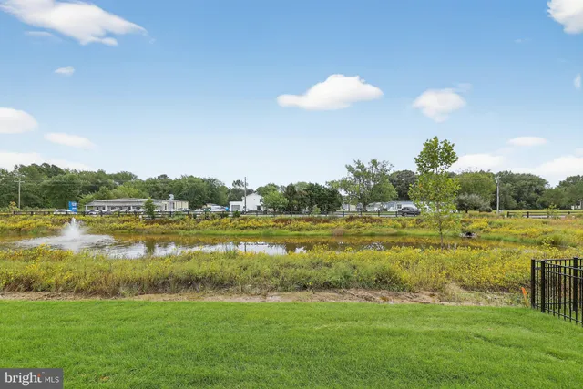 a view of a lake with a yard and mountain view