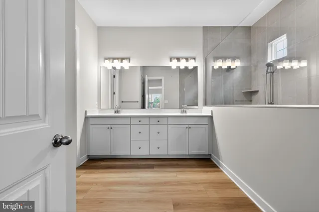 a bathroom with a sink vanity and a mirror
