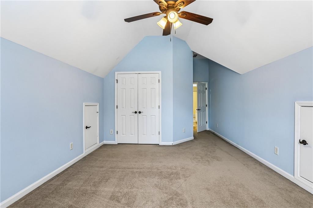 810 Freedom Way Cumming, GA 30040 - Photo 39 of 61 an empty room with closet and a chandelier fan