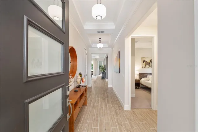 a kitchen with stainless steel appliances kitchen island granite countertop a stove a sink a refrigerator a dining table and chairs with wooden floor