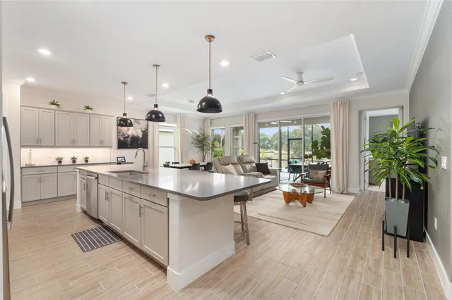 a kitchen with stainless steel appliances granite countertop white cabinets and a stove top oven