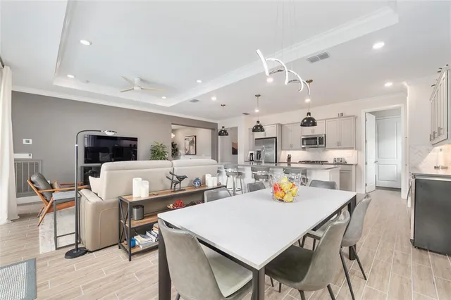 a bathroom with a double vanity sink a toilet a mirror and shower