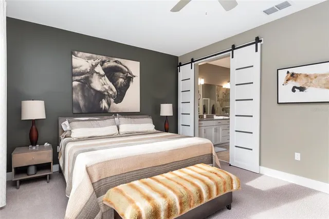 a bedroom with a bed next to a window