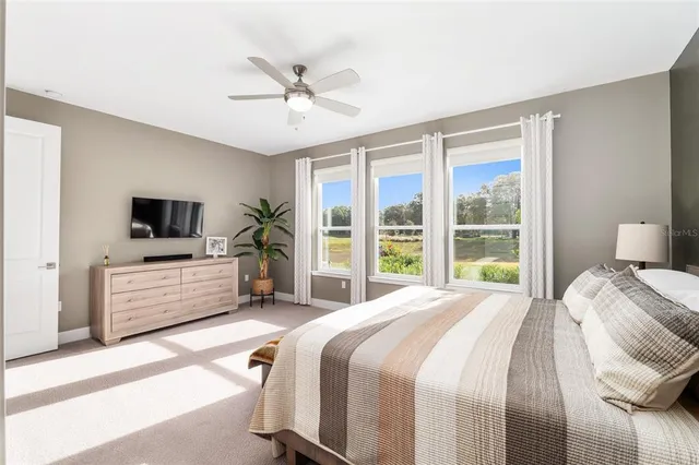 a view of a bedroom with furniture and windows