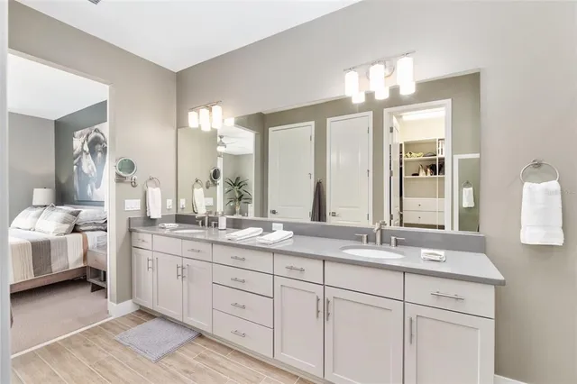 a view of a lake with table and chairs and potted plants
