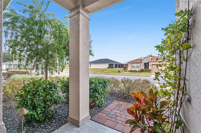 a view of a hallway with wooden floor and a bathroom