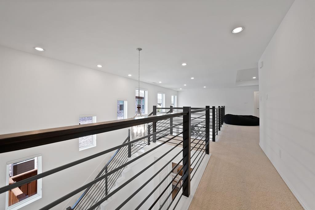 5012 Triadic Lane Prosper, TX 75078 - Photo 28 of 38 Upper-level landing featuring a contemporary metal railing system