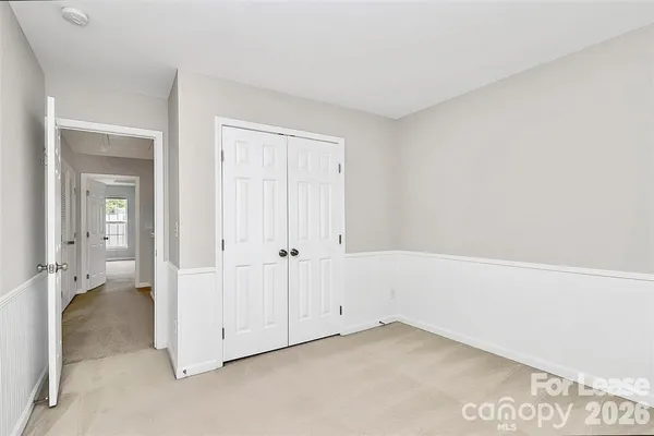 an empty room with closet area