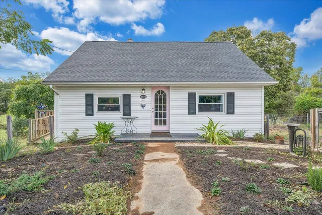 a front view of a house with garden