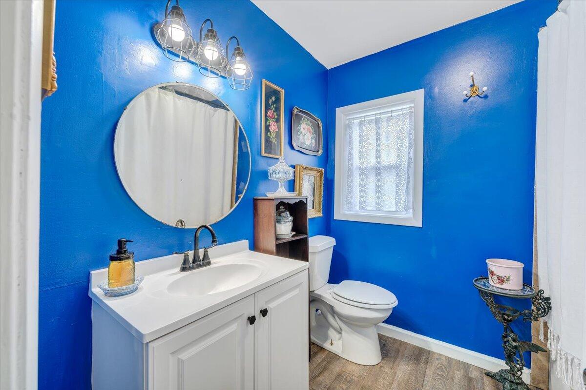 2410 Overlook Road Northeast Roanoke, VA 24012 - Photo 14 of 19 a bathroom with a toilet a sink and a mirror