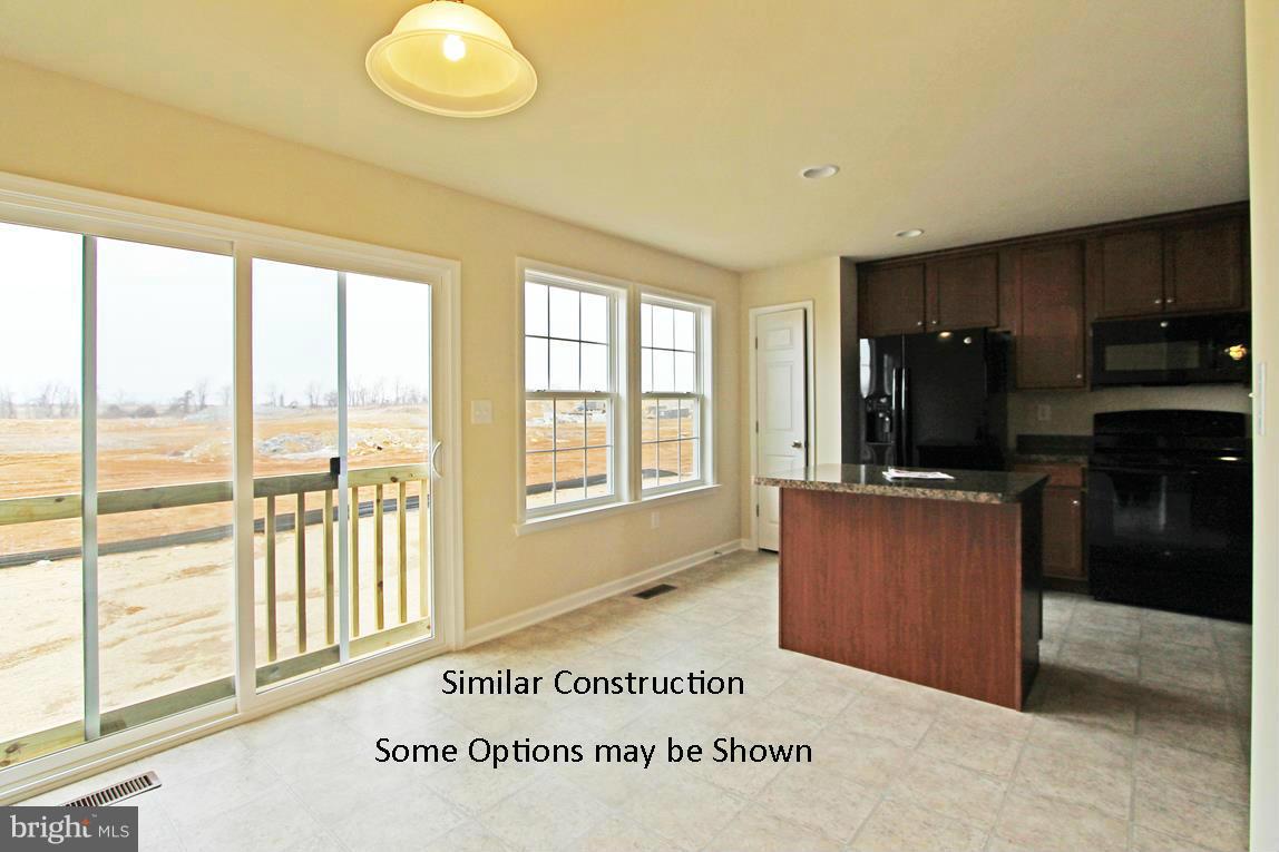 0 Stallion Street, Unit 408 Ranson, WV 25438 - Photo 11 of 30 a view of kitchen with windows cabinet and microwave