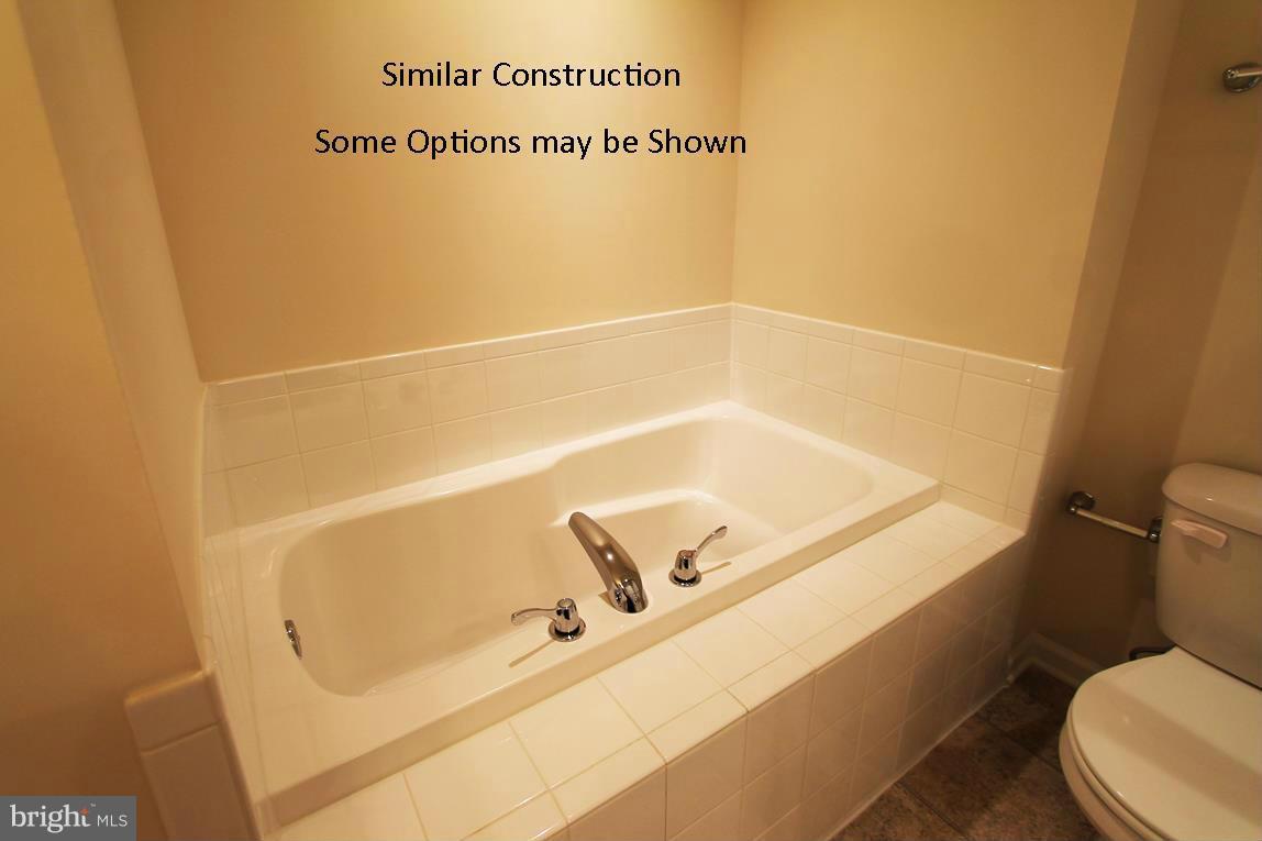 0 Stallion Street, Unit 408 Ranson, WV 25438 - Photo 16 of 30 a bathroom with a tub and toilet