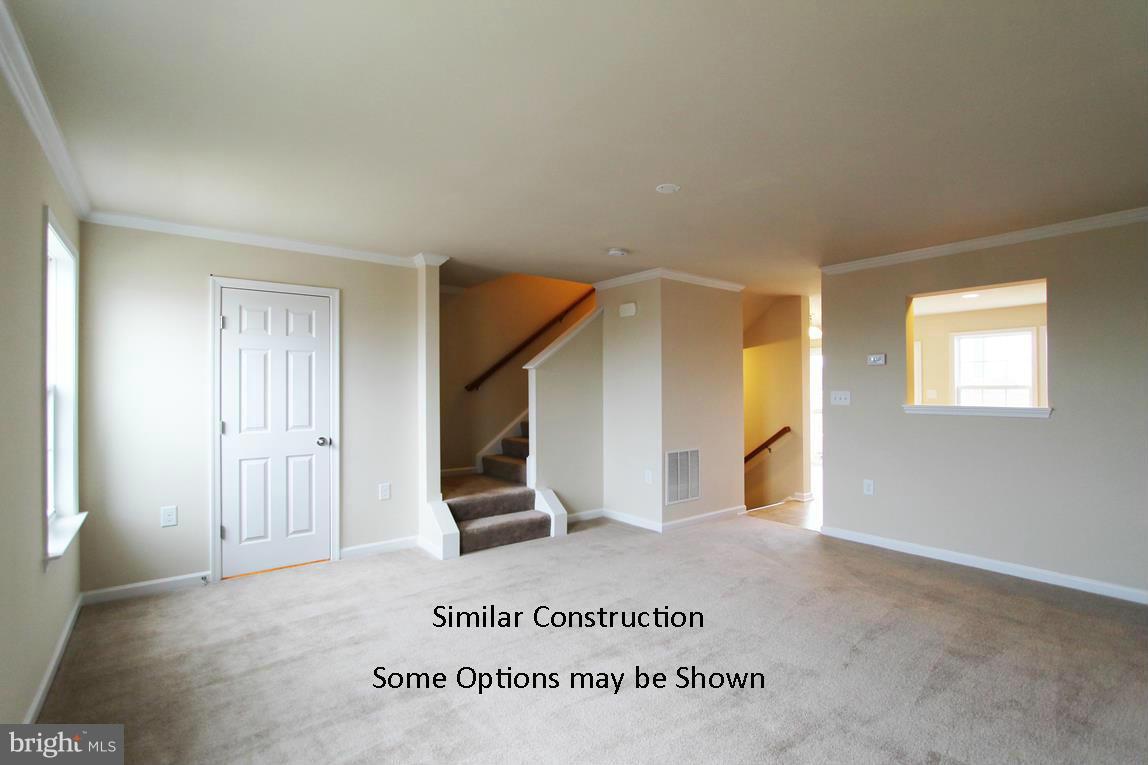 0 Stallion Street, Unit 408 Ranson, WV 25438 - Photo 6 of 30 a view of a hallway with wooden floor and staircase
