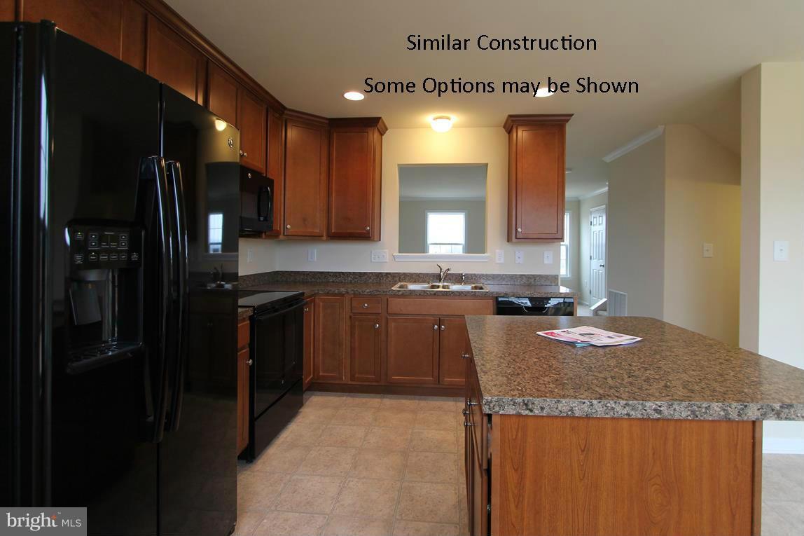 0 Stallion Street, Unit 408 Ranson, WV 25438 - Photo 10 of 30 a kitchen with granite countertop kitchen island stainless steel appliances a refrigerator sink stove microwave and cabinets
