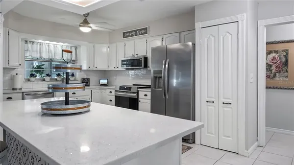 a spacious bathroom with a granite countertop sink mirror and shower