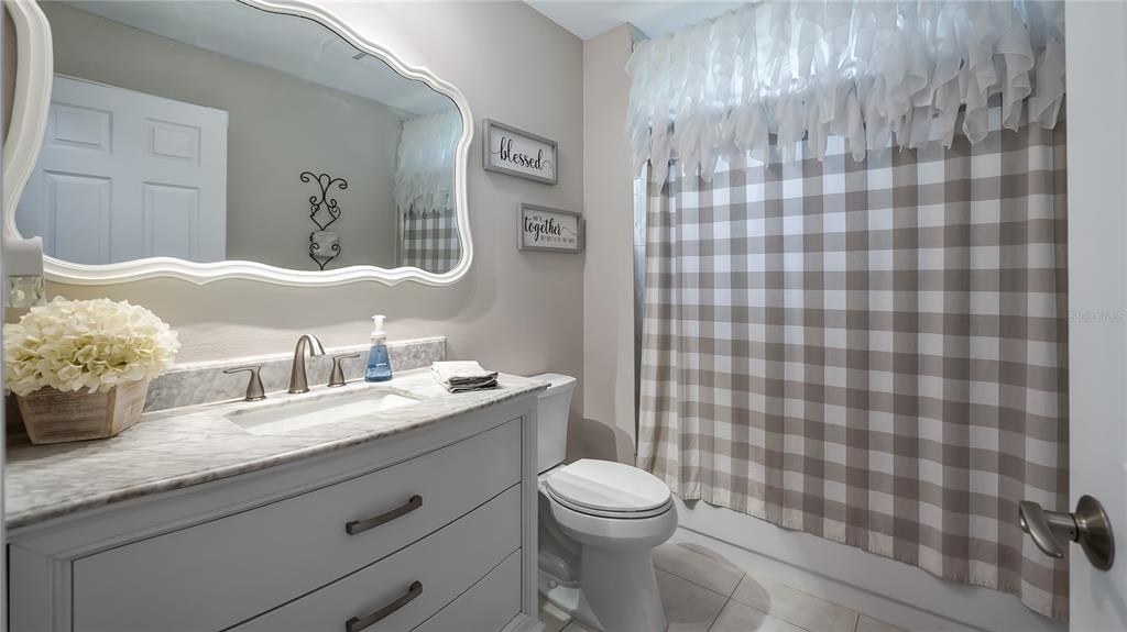 11136 Bronson Road Clermont, FL 34711 - Photo 12 of 29 a bathroom with a granite countertop toilet sink and mirror