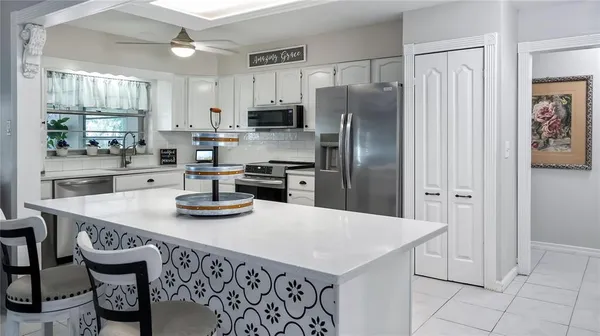 a kitchen with stainless steel appliances granite countertop a stove a sink and a refrigerator