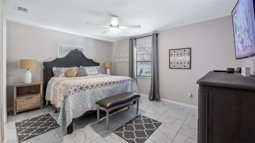 11136 Bronson Road Clermont, FL 34711 - Photo 14 of 29 a bedroom with a bed and a table in it