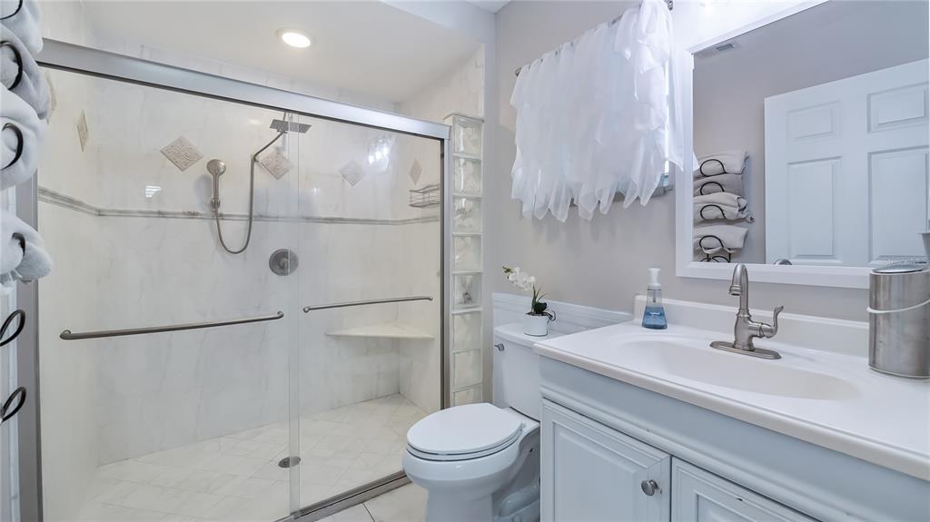 11136 Bronson Road Clermont, FL 34711 - Photo 15 of 29 a bathroom with a sink toilet and shower